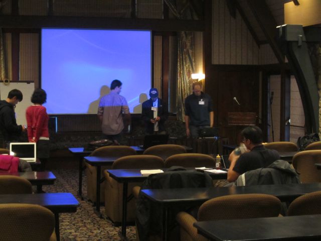 Dr. Harada helps to set up for his lab's presentations